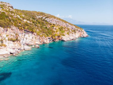 Drone shot of Zakynthos island with beautiful turquoise Ionian sea and limestone cliffs near famous Navagio beach during daytime in Greece