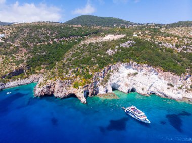 Drone shot of Zakynthos island with beautiful turquoise Ionian sea and limestone cliffs and cave near famous Navagio beach during daytime in Greece
