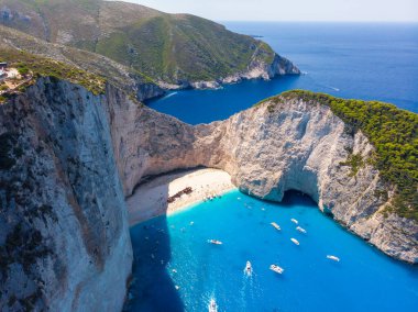 Drone shot of the famous Navagio beach and high limestone walls surrounding the shipwreck at the beautiful turquoise Ionian sea, Zakynthos (Zante) island, Greece
