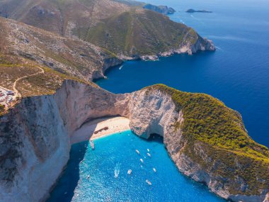 Drone shot of the famous Navagio beach and high limestone walls surrounding the shipwreck at the beautiful turquoise Ionian sea, Zakynthos (Zante) island in Greece