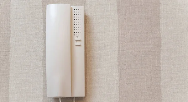 Intercom in the apartment on a white wall close-up