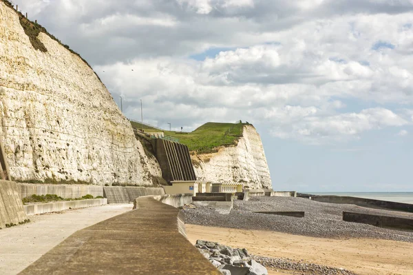 Doğu Sussex, İngiltere 'de Brighton yakınlarındaki Saltdean' da deniz kenarındaki gezinti güvertesi ve beyaz tebeşir kayalıkları