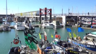 Brighton Marina, Doğu Sussex, İngiltere. Balıkçı tekneleri ve bayraklar rüzgarda dalgalanıyor..