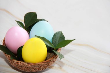 Festive multicolored Easter eggs in a decorative brown plate