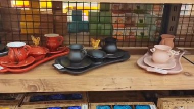 Antalya, Türkiye, 24 Mart 2023. Doğu tarzında çeşitli seramik renkli kahve setleri. Vitrinde bardaklar ve tabaklar var.