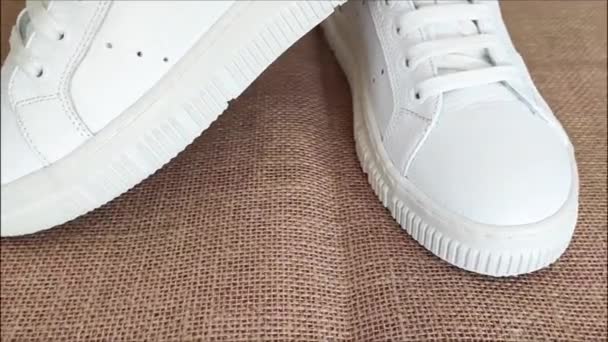 White Leather Sports Sneakers Laces Brown Background — Stock Video