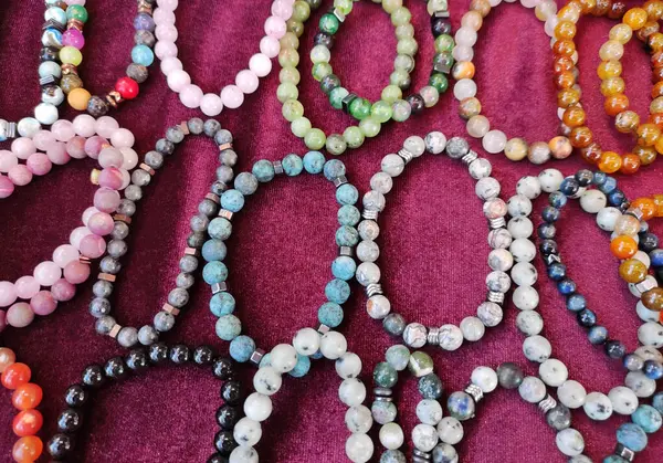  Çok renkli yuvarlak boncuklardan yapılmış bileklikler.