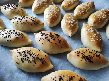 Doldurulmuş lezzetli oryantal turtalar, mis kokulu tohumlar serpiştirilmiş.