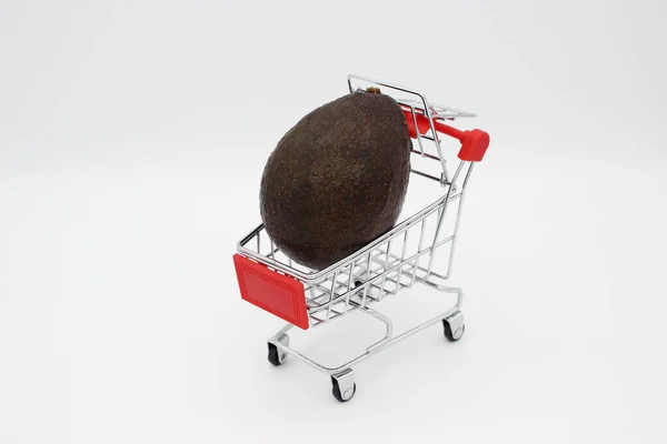 Avocado in metal store basket on white background