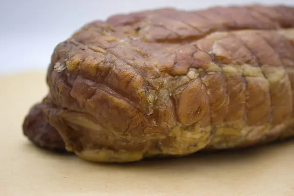 stock image Close-up view of a smoked pork loin cut, revealing the tender and juicy interior. The meat's subtle pink hue highlights the perfect smoking process that preserves moisture and enhances flavor.