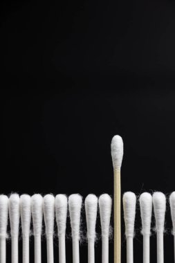 Ecological cotton toothpick that stands out from other non-ecological ones. Concept of ecology and zero waste.