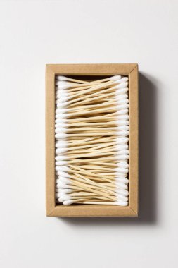 Cardboard box filled with bamboo ear sticks. Zero waste concept.