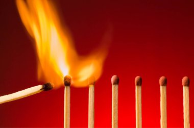 Match lighting other matches. Concept of transmitting ideas and motivations.