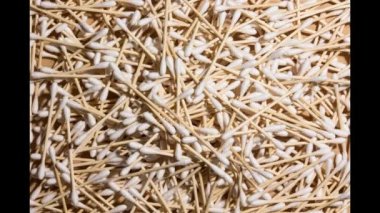 A bunch of cotton swabs that disappear until only one remains. Non-plastic concept. Stop motion sequence.