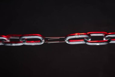 Thick chain with a paper clip holding it together. Weakest link concept.