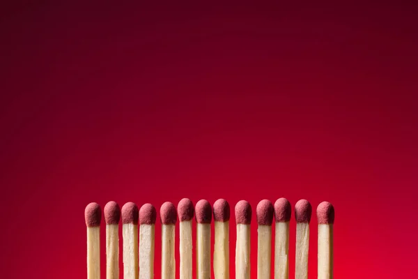 Set of matches form an orderly row. Conclave concept.