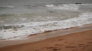 Deniz dalgaları kumlu sahile çarpıp beyaz köpük oluşturuyor. Calpe, Costa Blanca, İspanya 'nın resimli deniz kıyısı. Büyük deniz dalgaları kumsala ulaşıyor.