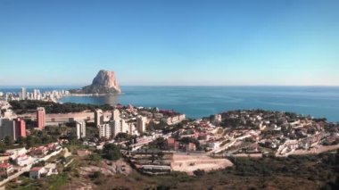 Coastal line of Spanish tourist city Calpe, Costa Blanca, Spain. Beautiful cityscape with lots of high buildings and residential complexes. Summer holiday vacations. Travel and tourism concept