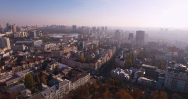 Cityscape of Kyiv city, Ukraine. Aerial view of center of city Kyiv with Olympijsky stadion on background. Flying over National Sports Complex Olympiyskiy and  lots of high buildings in center of Kyiv