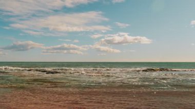 Coastline of Mediterranean Sea at sunny day with big sea waves and sandy beach. Amazing seascape