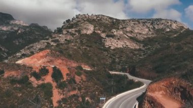 Cycling training. Cyclist riding bicycle uphill in mountains. Pro triathlete cycling on road bicycle, hard training, doing intense cardio workout. Fitness activity. Cycling and triathlon concept
