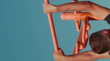 Sporcu spor salonunda barfiks egzersizi yapıyor. Dikey video. Atletik güçlü adam spor sahasında egzersiz yapıyor. Spor konsepti. Fitness çalışma etkinliği