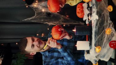 Cadılar bayramın kutlu olsun. Mutlu çift arkadaşlar Cadılar Bayramı partisinde turuncu balkabağı boyar. Dikey video. Şeker mi şaka mı? Geleneksel Cadılar Bayramı sembolleri. Cadılar Bayramı kutlaması. Cadılar Bayramı için hazırlık.