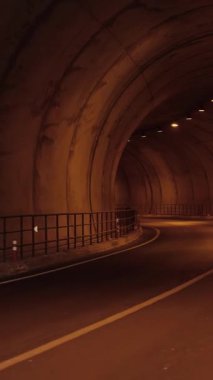 Running concept. Young muscular man runs along tunnel, exercising endurance training. Runner athlete jogging workout. Fitness activity. Sport concept. Vertical video