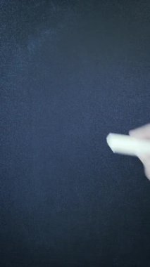 Hand writing word Idea on chalkboard with chalk, close up. Vertical video