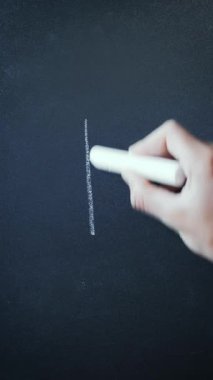 Male hand writing word death on blackboard with chalk, close up. Word death written on chalkboard. Vertical video