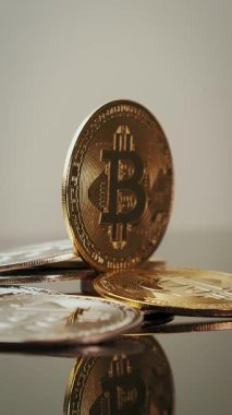 Model of golden bitcoin shining and rotating. Bitcoin blockchain cryptocurrency. Vertical video