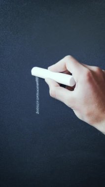 Hand writing Bitcoin and drawing line showing increase. Word bitcoin written on chalkboard. Bitcoin drawn on blackboard in chalk. Vertical video