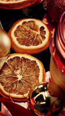 Beautifully decorated christmas table with candle light. Elements of Christmas decor in red and gold colors. Vertical video