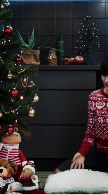 Woman is greeting relatives and friends on Christmas eve online by distance video call. Happy smiling female is celebrating Christmas using video call. Vertical video