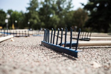 The rake spread out on the sidewalk. Many new rakes laid out on the road. The concept of mistakes and difficulties in life. clipart