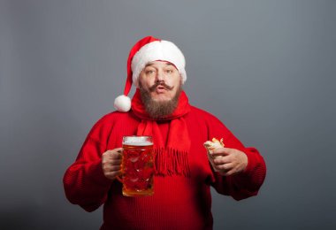 An elderly man with a beard in the cap of Santa Claus with a glass of beer and a hot dog clipart