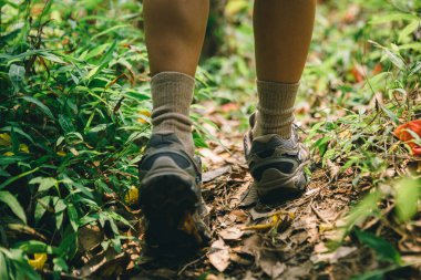 Bahar dağlarında yürüyüş yapan kadın bacakları.
