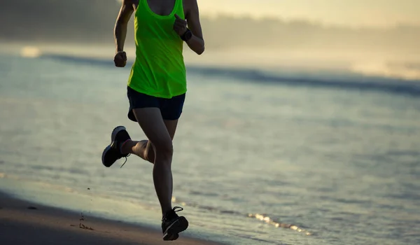 stock image Healthy lifestyle young fitness woman running on sunrise beach