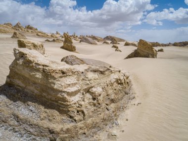 Aerial view of landscape in desert under blue sky