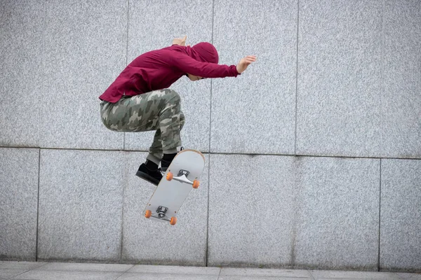 stock image Asian woman skateboarder skateboarding in modern city