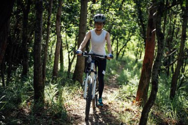 Mountain biking in summer forest