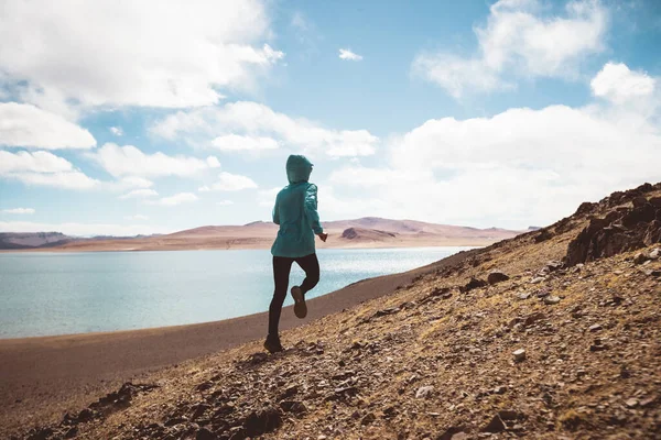 stock image Woman trail runner cross country running in lakeside mountains