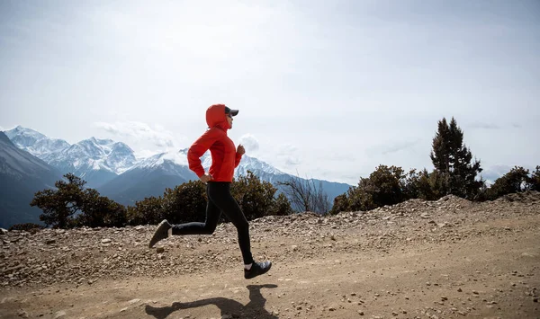 stock image Woman trail runner cross country running at high altitude mountains