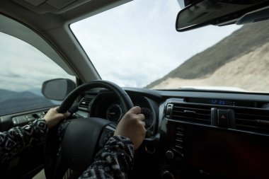 Driving car on high altitude mountain trail, China clipart