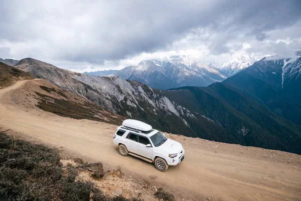 stock image Driving car on high altitude mountain trail, China