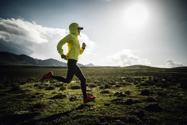 stock image Woman runner running at mountain top