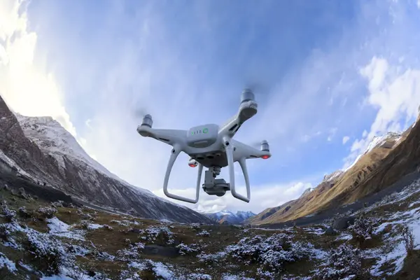 Beyaz uçan dron Tibet, Çin 'deki manzaranın fotoğrafını çekiyor.