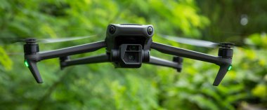 Flying drone in summer forest