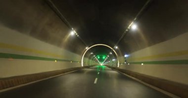 Yeraltı tünelinde ışıklarla giden araba.