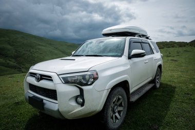 Tibet, Çin - 14 Haziran 2023, Toyota 'yı yüksek rakımlı çayır dağlarında yoldan çıkarmak